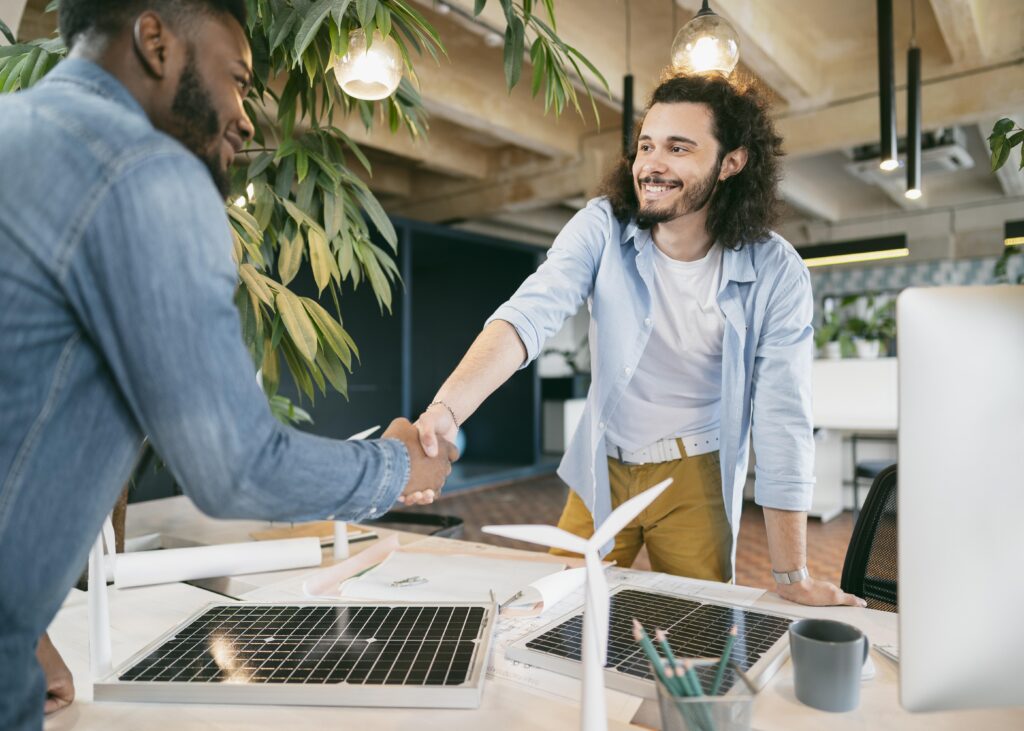 Dutch job market: two men shaking hands in an office.