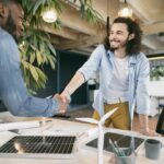 Dutch job market: two men shaking hands in an office.