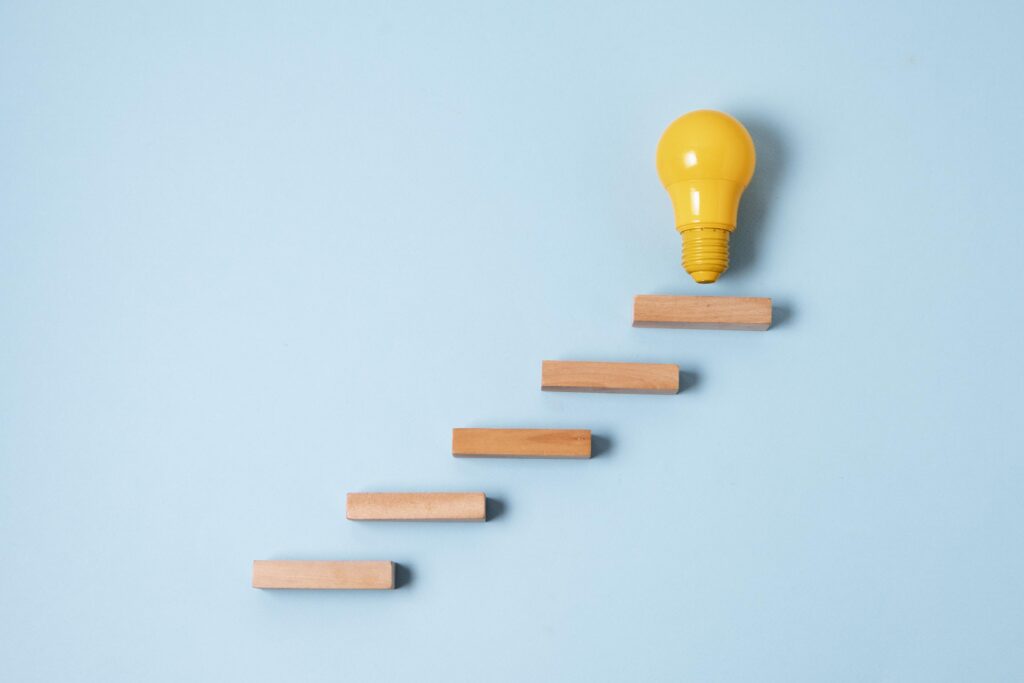 Light bulb on wooden steps