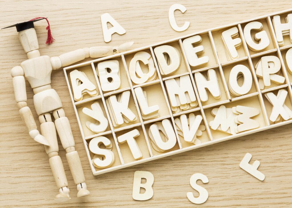 Wooden figurine with letters.