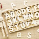 Wooden figurine with letters.