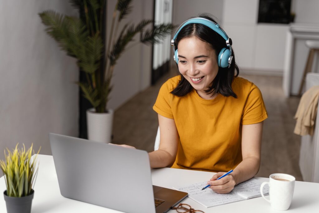 Woman with headphones attending an online class.