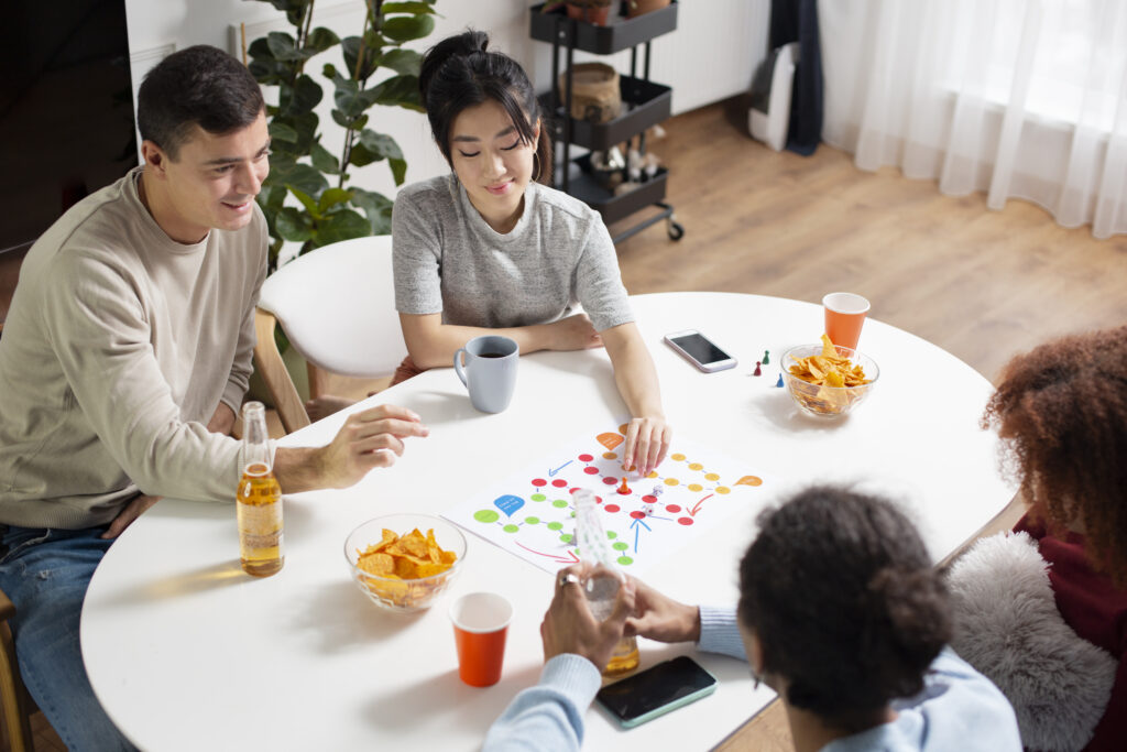 Friends having fun and practicing Dutch with board game.